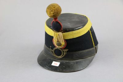 a black hat with a yellow band and a brown pom pom
