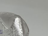 a glass bottle that has a picture of a person on it