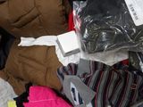 a box full of clothes and other items that are on the floor