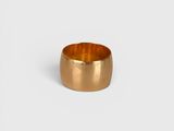 a close up of a gold ring on a white background
