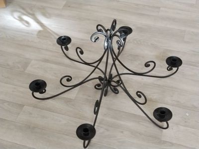 a candle holder that is on the floor in the room