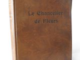 brown leather book with black lettering on it sitting on a white surface