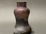 a vase that is sitting on a table with a gray background