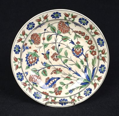 a close up of a plate with flowers on it on a black background