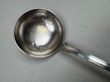 a silver spoon with a handle on a table