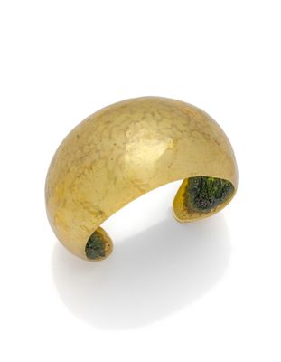 an image of a close up of a gold ring on a white surface