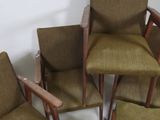 several chairs with arms and legs are lined up in a circle