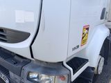 a picture of a white truck parked in a parking lot