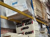 boxes are stacked on a pallet in a warehouse with a sign that says don ' t stop now