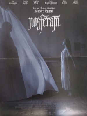 an image of a movie poster with a woman standing in front of a ghost