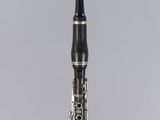 a close up of a clarinet on a gray background