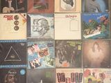 a lot of records on the wall of a room