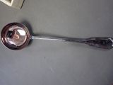 a spoon with a mirror on it sitting on a table