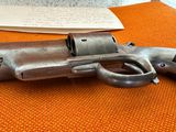 an old gun on an orange table with a note and pen