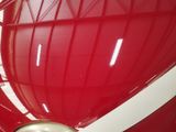 a red heart shaped object on display in a building