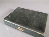 a small black box with a gold handle on a table