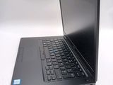 a laptop computer sitting on a table with a keyboard
