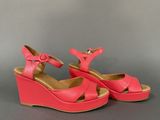 pink wedged sandals with buckles on the toes and a platform