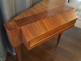 a wooden desk with a drawer underneath it on a hard wood floor