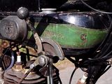 a close up of a motorcycle with a green and black engine