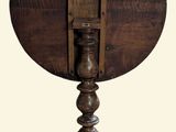 a small wooden table with a clock on top of it