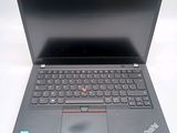 a black laptop with a red button on the keyboard