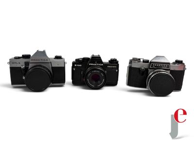 two old cameras are sitting next to each other on a white surface