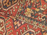 a close up of a red and blue rug with a pattern on it