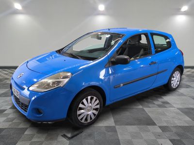 a blue car is parked in a room with a checkered floor