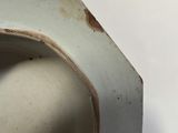 a close up view of a white vase with rust on it