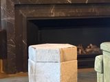 two chairs in front of a fireplace in a living room