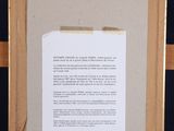 a framed picture of a piece of paper on a easel