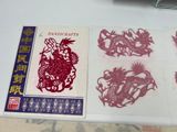 a lot of red paper cut designs on a table