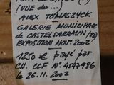 a piece of paper on a piece of wood with writing on it