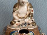 a statue of a buddha sitting on top of a box