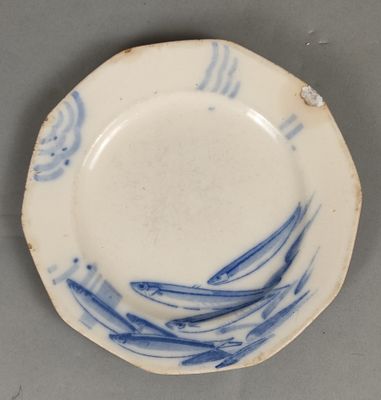 a blue and white plate with a wave design on it