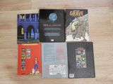 several books on a wooden floor with a picture of a castle in the background