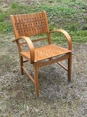 a wooden chair that is sitting in the grass