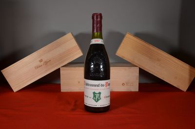 a bottle of wine sitting on a table next to two wooden boxes