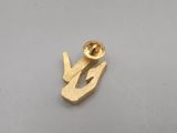 a close up of a gold plated metal object on a white surface