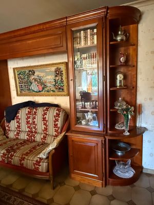 a living room with a couch and a bookcase