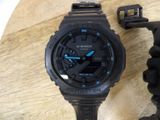 a close up of a watch on a wooden table
