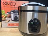 a silver slow cooker sitting on a table next to a box of food