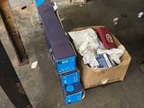 a box of assorted items on the floor of a garage
