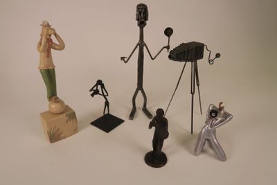 several figurines of different types and sizes are displayed on a white surface