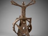 an image of a bronze sculpture of a man holding a wheel