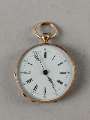 a gold pocket watch with roman numerals on the face