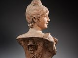 an image of a busturine of a woman wearing a hat