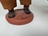 a figurine of a man standing on top of a base