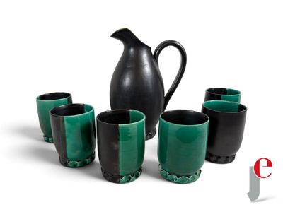 five cups and a pitcher sitting next to each other on a table